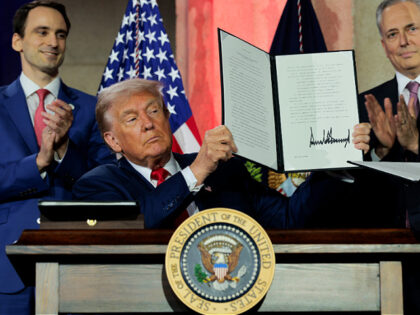 WASHINGTON, DC - JULY 23: U.S. President Donald Trump displays a signed executive order du