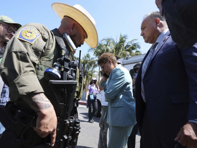 Karen Bass (Damian Dovarganes / Associated Press) Los Angeles Mayor Karen Bass talks on her mobile phone next to a border patrol federal age