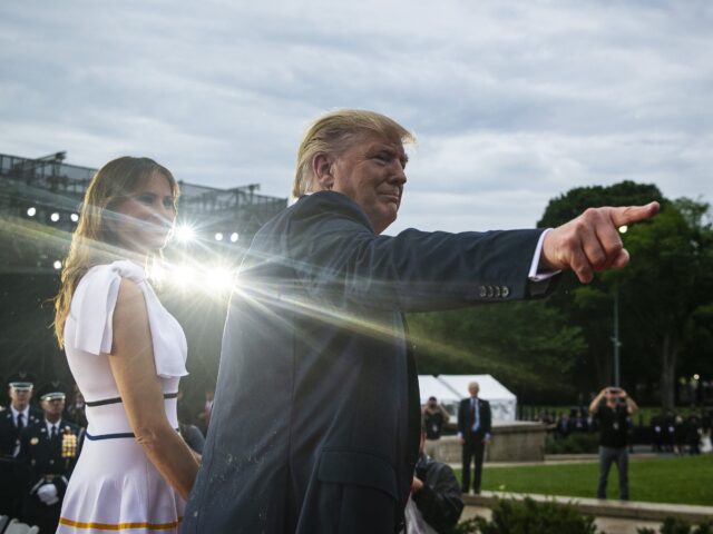 U.S. President Donald Trump, right, points as he stands with U.S. First Lady Melania Trump