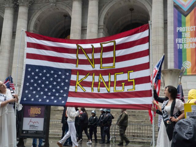 No Kings flag upside down (John Senter/UCG/Universal Images Group via Getty) Prior to a huge protest march, two women, wearing long, flowing dresses and sashes, hold a