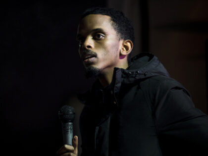 Omar Fateh, a member-elect of the Minnesota State Senate, speaks during a vigil for Dolal