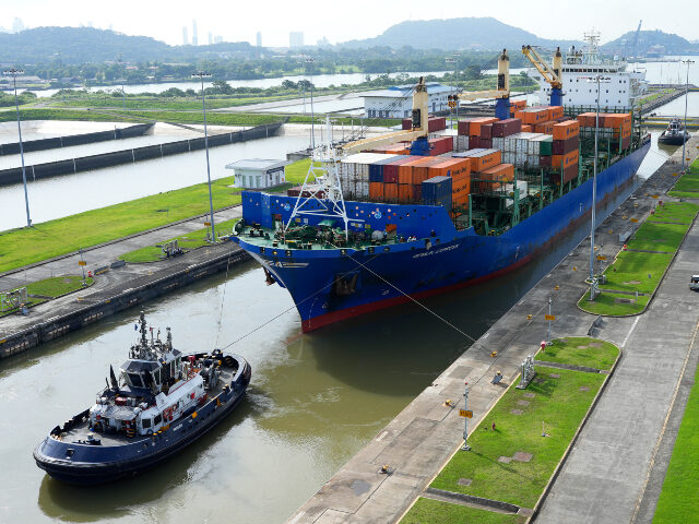Panama Canal (1) A cargo ship and tugboat sail through the Cocoli Locks at the Panama Canal, in Panama, on