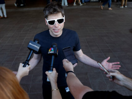 Sam Altman speaks to members of the media as he arrives at the Sun Valley lodge for the Al