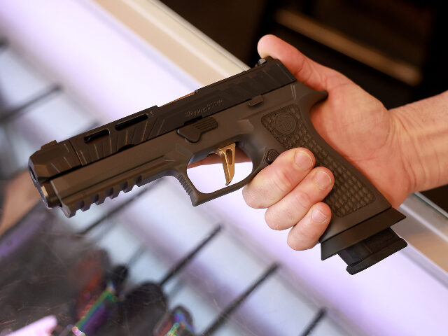 A Sig Sauer P320 handgun is held at the WEX Gunworks store on January 31, 2023 in Delray B