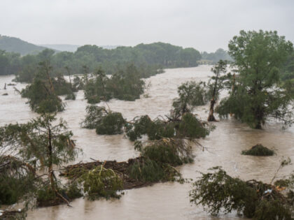 Trees emerge from flood waters along the Guadalupe River on July 4, 2025 in Kerrville, Tex