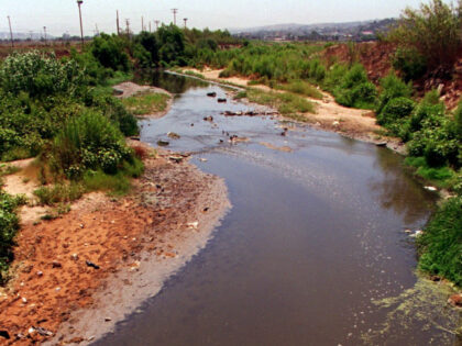 Raw sewage, fecal matter, toilet paper, et al, flowing West in the Tijuana River towards t