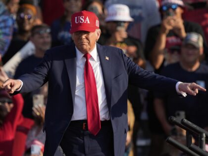 President Donald Trump arrives to speak at a rally at the Iowa State Fairgrounds, Thursday