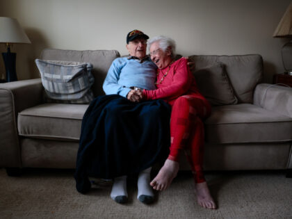 World War II veteran Morry Casso shares a laugh with his wife Niecy, while sitting for a p