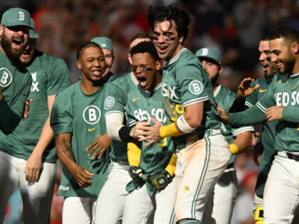 Ceddanne Rafaela #3 of the Boston Red Sox celebrates with teammates after hitting a two-ru