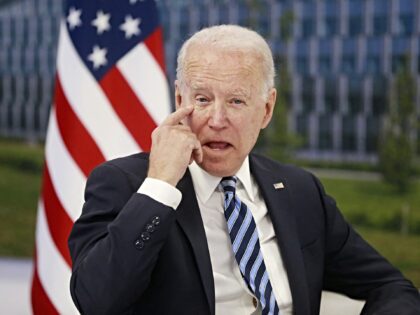 US President Joe Biden scratches his eye as he meets with NATO Secretary General during a
