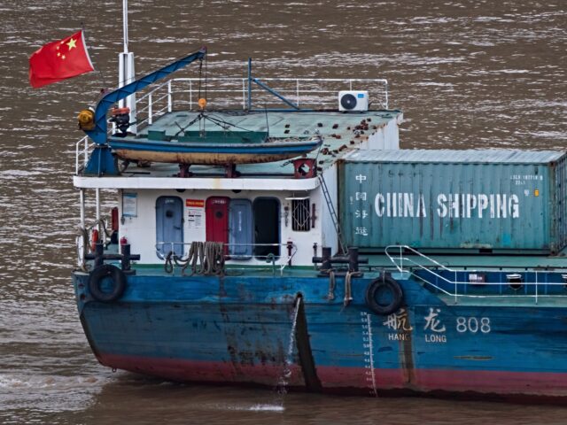 CHONGQING, CHINA - JULY 17: A Chinese cargo vessel carrying a China Shipping container and