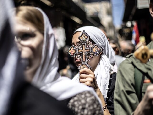 JERUSALEM - APRIL 18: Christians coming from around the world carrying wooden crosses marc