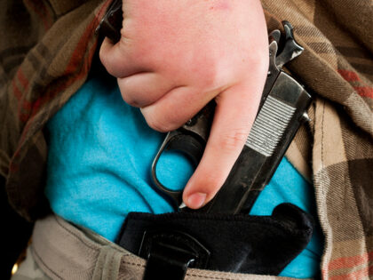Concealed Carry Firearm Drawn From an Inside-the-Waistband Holster - stock photo
