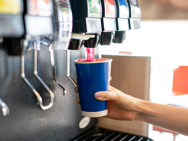 fountain-drinks-soda-machine-stock-gettyimages Man pours a fizzy drink.sparkling water.cool ice soft drink cola - stock photo