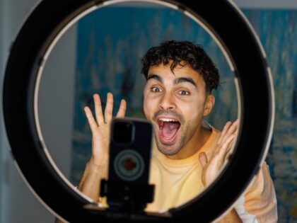 gay man filming a TikTok video