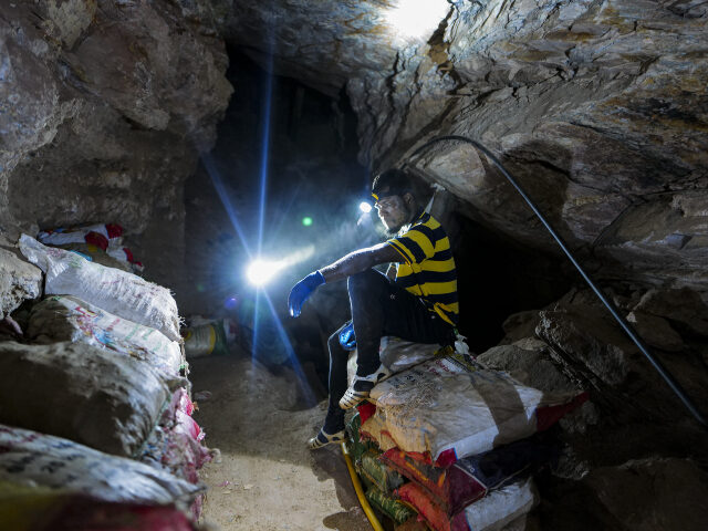 A miner takes a break inside an underground mine at a legal small-scale gold mining site i