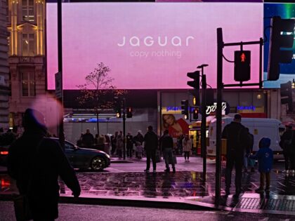 Digital screens at Piccadilly Circus display an advertisement for the Jaguar Type 00 conce