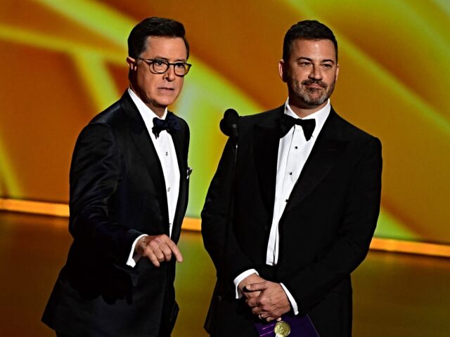Stephen Colbert (L) and Jimmy Kimmel speak onstage during the 71st Emmy Awards at the Micr
