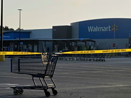 A shopping cart anchors police tape outside a Walmart where multiple people were stabbed i