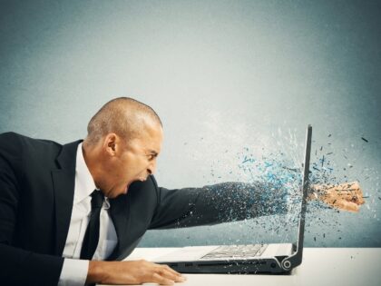 Man punching through his laptop