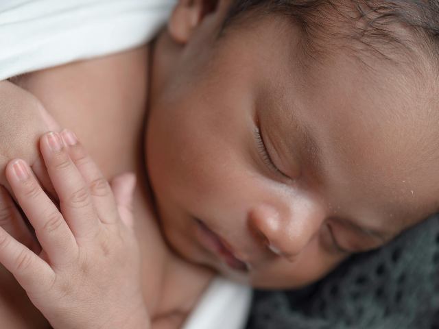Baby Sleeping While Covered White Coat