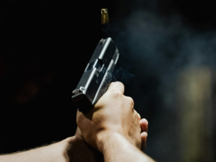 Back View of a Person Holding a Gun