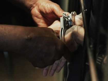 Handcuffs on hands of Prisoner in Jail