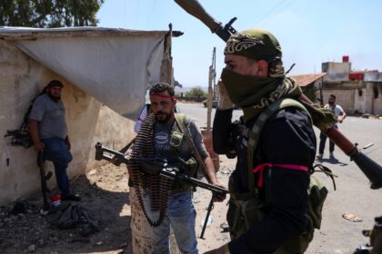 Armed Bedouin gather in the village of Al-Mazraa outside Sweida as clashes flare with Druz