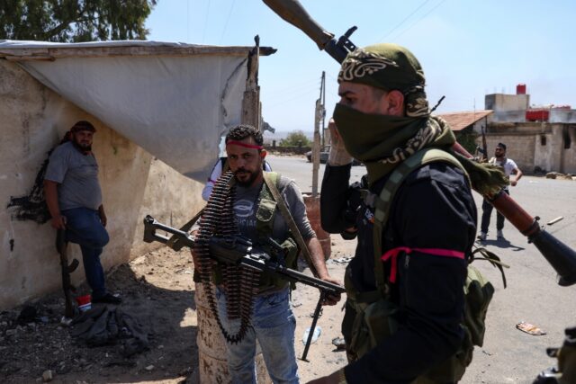 Armed Bedouin gather in the village of Al-Mazraa outside Sweida as clashes flare with Druz