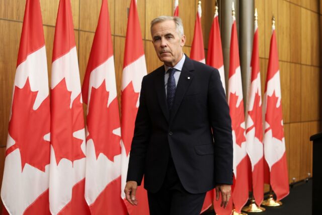 Canadian Prime Minister Mark Carney exits a press conference after announcing plans to rec