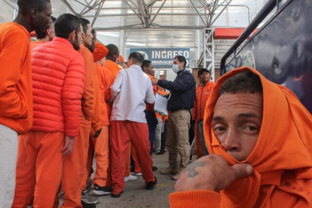 Colombian inmates wait to be registered by immigration agents after being deported from Ec