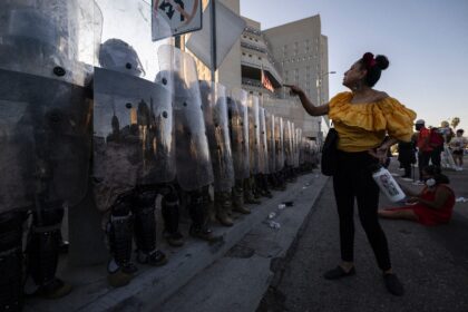 A demonstrator interacts with US marines and national guards in Los Angeles on July 4, 202