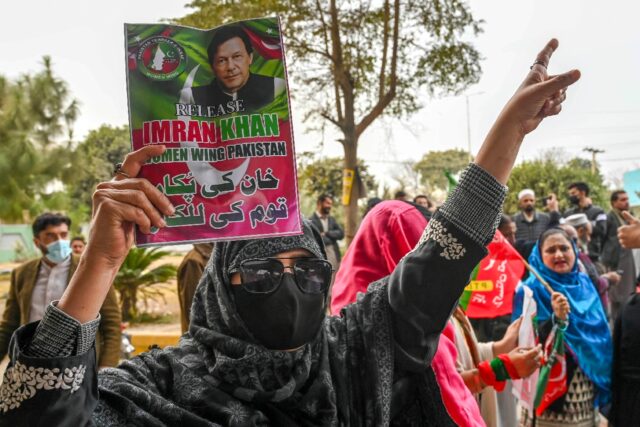 A supporter of Pakistan's former prime minister Imran Khan hold his portrait during a
