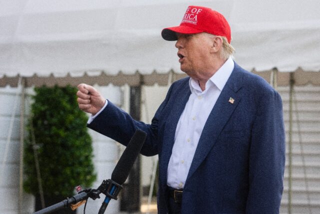 US President Donald Trump talks to members of the press as he departs from the South Lawn