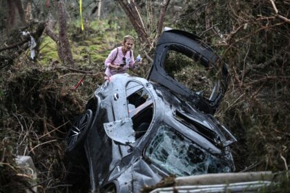 A volunteer looks for missing people, following severe flash flooding that occured during