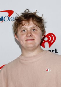 Lewis Capaldi performs amid flowers in 'Survive' music video