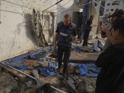 Palestinians inspect the destroyed tent where journalists, including Al Jazeera correspond