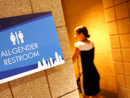 An all-gender restroom sign is posted on the first day of the Democratic National Conventi