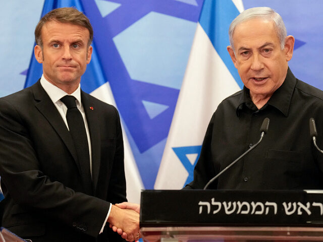 Benjamin-Netanyahu-Emmanuel-Macron-oct2023-getty TOPSHOT - Israeli Prime Minister Benjamin Netanyahu (R) shakes hands with French President