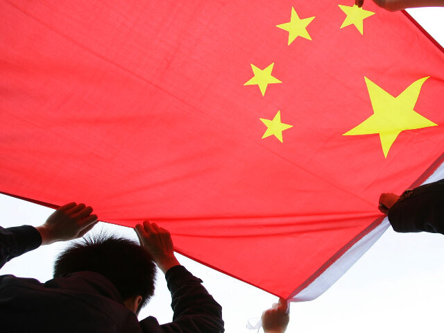 Chinese flag being held up by man Chinese protesters carry the national flag as they march during an anti-Japanese demonstra