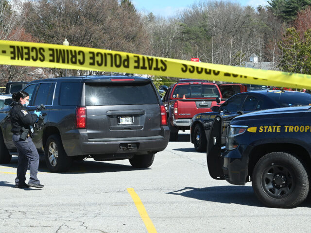 A state trooper takes photos of the scene outside the State Police barracks on Route 9 aft