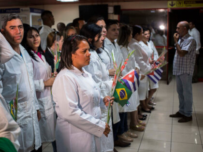 Cuban doctors assemble to meet Cuba's President Miguel Diaz-Canel after landing in Ha