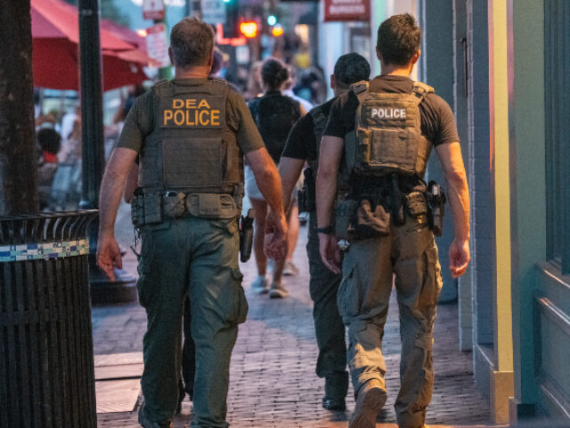 DEA agents patrol through the streets of the popular tourist area Georgetown on August 16,