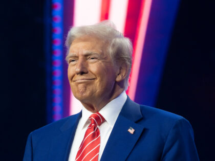 U.S. President-elect Donald Trump smiles during Turning Point USA's AmericaFest at th