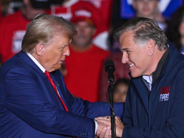 Donald Trump and Mike Rogers Former US President and Republican presidential candidate Donald Trump shakes hands with U