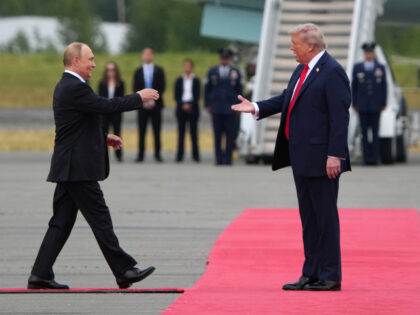 U.S. President Donald Trump (R) greets Russian President Vladimir Putin as he arrives at J