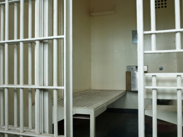 Empty jail cell with open door