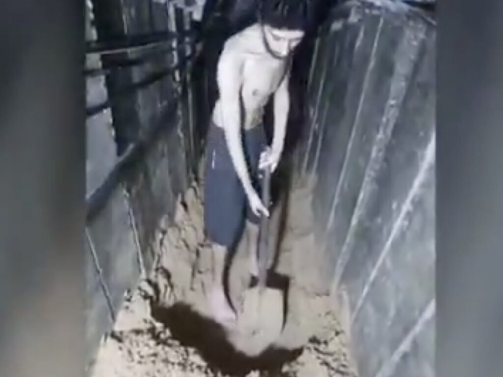 A screengrab from vision released by the Hamas terror organizations shows Evyatar David digging his own grave.