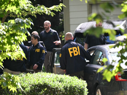 FBI agents are seen outside John Bolton's house, Donald Trump's former national