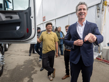California Governor Gavin Newsom looks at alternative fuel trucks at World Energy Paramoun